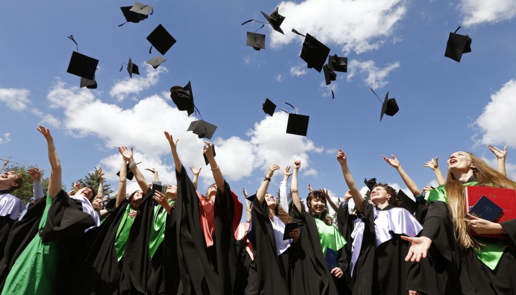 Medical University graduates throw up mortarboards during the celebration of their graduation in Minsk